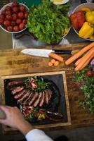 top view of Chef finishing steak meat plate photo