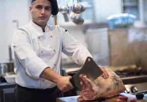 chef cutting big piece of beef photo