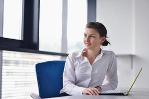 Young pretty business woman with notebook in the office photo