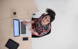 top view of young business woman working on laptop photo