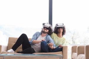 Multiethnic Couple using virtual reality headset photo