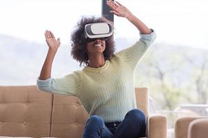 black woman using VR headset glasses of virtual reality photo