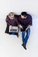 top view of  couple working on laptop computer at startup office photo