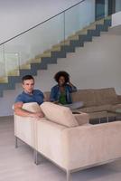 multiethnic couple relaxing at  home with tablet computers photo