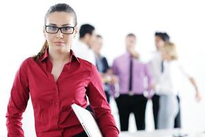 business woman standing with her staff in background photo