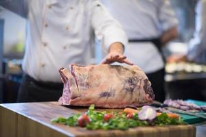 chef cutting big piece of beef photo