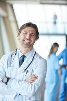 group of medical staff at hospital, handsome doctor in front of team photo