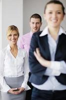 business woman standing with her staff in background photo