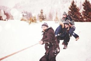 group of young people pulling a rope in tug of war competition photo