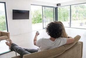 Rear view of couple watching television photo