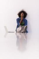 african american woman sitting on floor with laptop photo