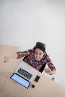 top view of young business woman working on laptop photo