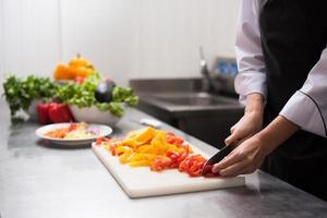 Chef cutting fresh and delicious vegetables photo