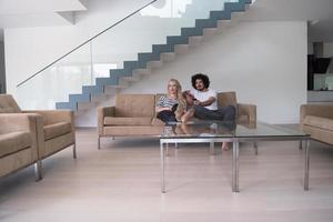 Young couple on the sofa watching television photo