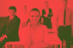 business woman standing with her staff in background photo