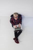 top view of young business woman working on laptop computer photo
