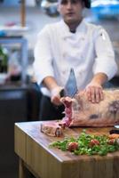 chef cutting big piece of beef photo