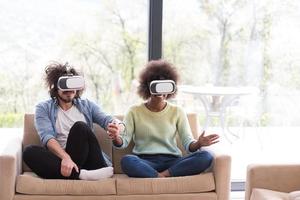 Multiethnic Couple using virtual reality headset photo