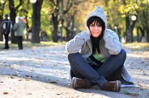 brunette Cute young woman  sitting  in nature photo