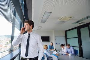 business man  on a meeting in offce with colleagues in background photo