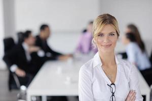 business woman standing with her staff in background photo