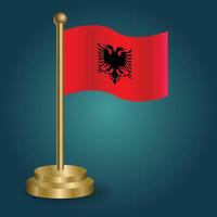 Albanian national flag on golden pole on gradation isolated dark background. table flag, vector illustration