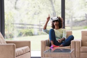 black woman using VR headset glasses of virtual reality photo