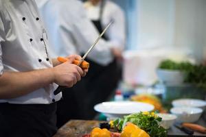 chef hands cutting carrots photo