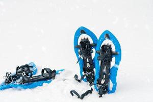 Blue snowshoes in fresh show photo