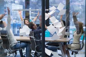 startup Group of young business people throwing documents photo