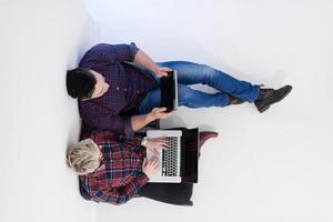 top view of  couple working on laptop computer at startup office photo