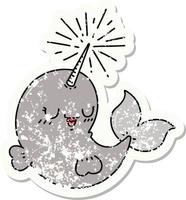 worn old sticker of a tattoo style happy narwhal vector