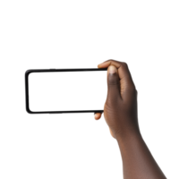 Black hand holding phone facing camera isolated on transparent background. blank screen, phone screen mockup, front view, clipping path, clipping mask png