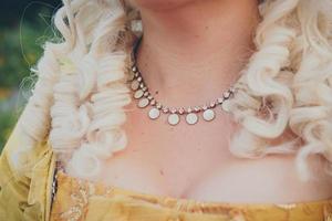 Luxurious medieval necklace on the womans neck, close up, selective focus photo