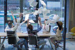 startup Group of young business people throwing documents photo