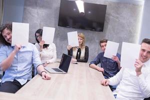 startup business team holding a white paper over face photo