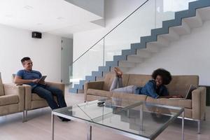 young multiethnic couple relaxes in the living room photo