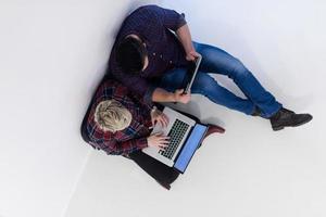 top view of  couple working on laptop computer at startup office photo