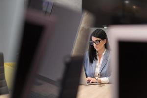 businesswoman using a laptop in startup office photo