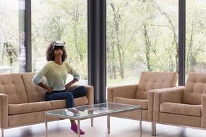 black woman using VR headset glasses of virtual reality photo