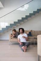 couple relaxing at  home with tablet computers photo