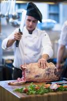 chef cutting big piece of beef photo