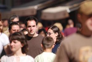 happy man walking in crowd photo