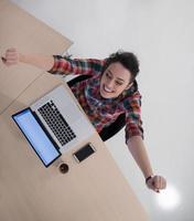 top view of young business woman working on laptop photo