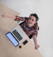 top view of young business woman working on laptop photo