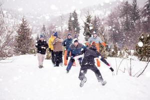 group of young people having fun in beautiful winter landscape photo