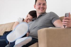 young couple hugging on the sofa photo