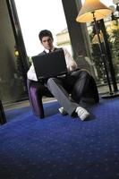 young businessman working on laptop photo