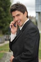 Photo of happy winner businessman  talking on mobile phone
