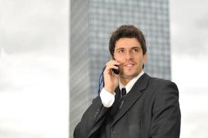 Photo of happy winner businessman  talking on mobile phone
